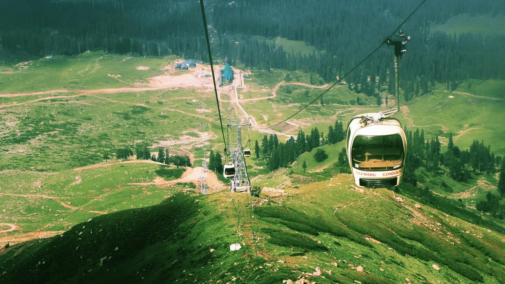 Gulmarg Gondola cable car above snowy slopes