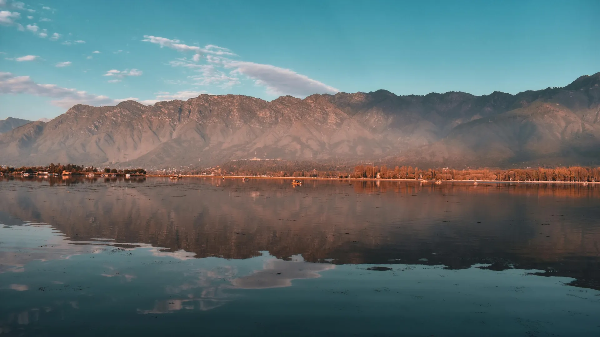 Lake near mountain under blue sky